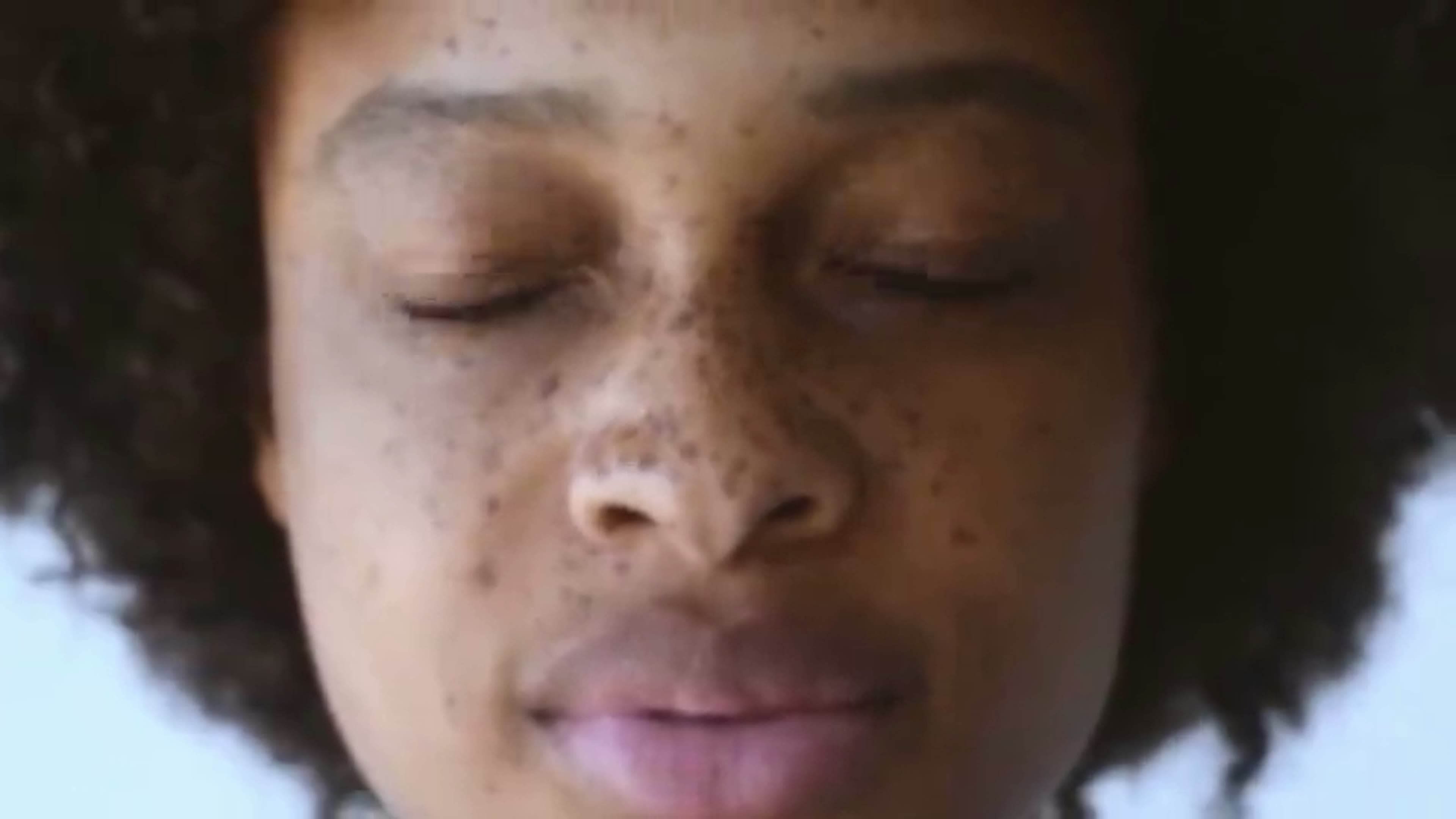 Close-up of a freckled face at 480p