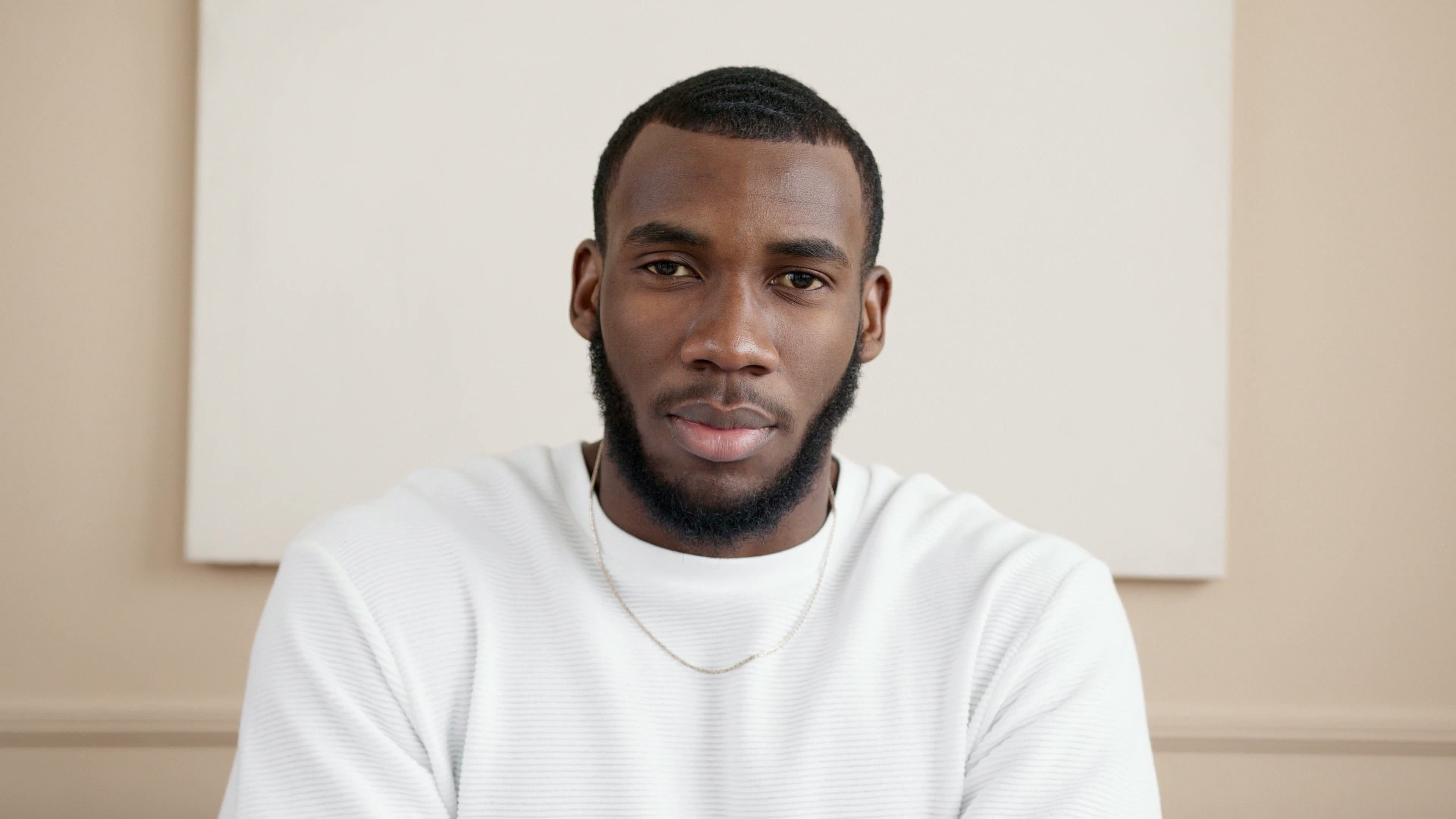 Bearded man in a white sweater, clean and sharp in 4K
